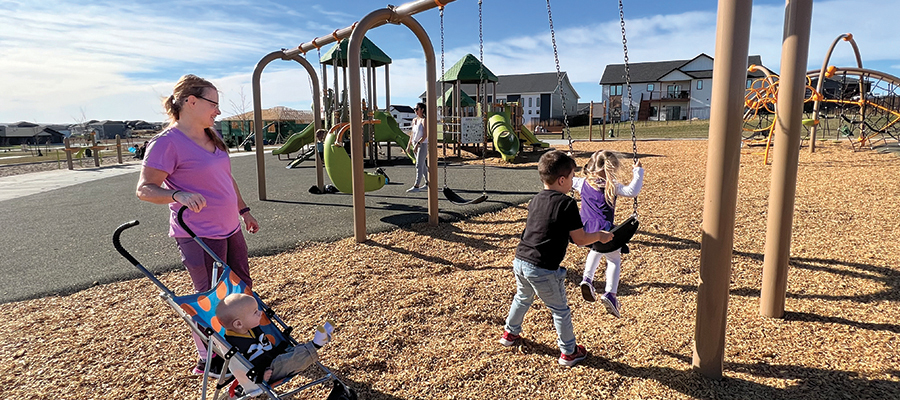 Mom and kids playing on playground