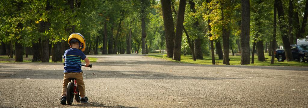 kid riding bike in park