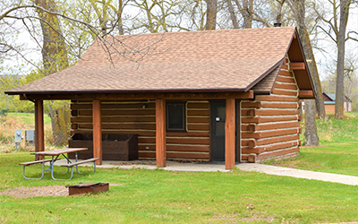 John Colter Cabin exterior with picnic table
