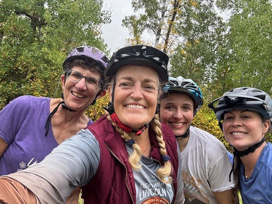Smiling women take a selfie in bike helmets