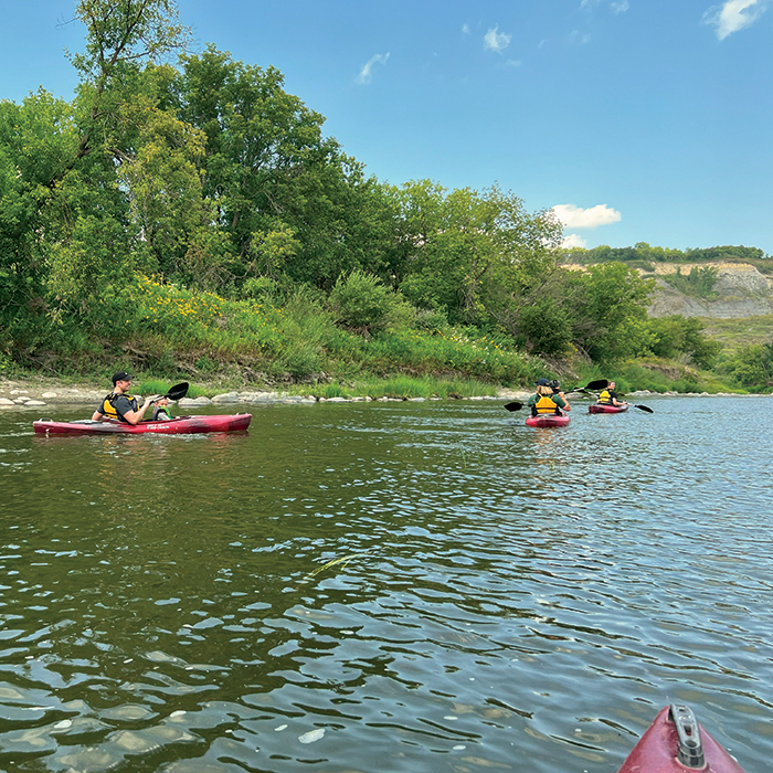 Kayakers paddle down the Pembina River